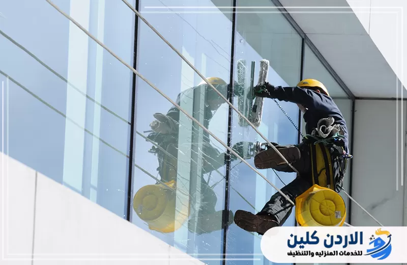 تواصل مع الأردن كلين لتنظيف النوافذ بالحبال 0798779667. فني مثبت بالحبال يستخدم ممسحة احترافية لتنظيف زجاج النوافذ وإزالة آثار المياه والغبار.